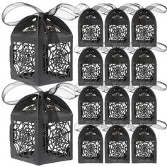 six black birdcages with ribbons tied around the top and one has a bow on it