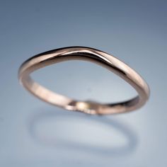 a close up view of a wedding ring on a blue background with copy space in the middle