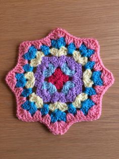 a crocheted doily on a wooden surface