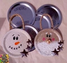 three tins with snowmen and stars hanging from the top one has a face on it