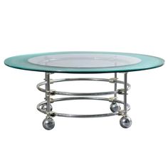 an oval glass table with metal wheels