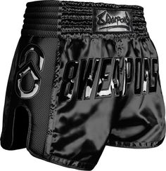 the black boxing shorts with silver lettering on it