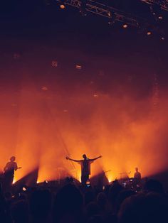 a man standing on top of a stage in front of a crowd