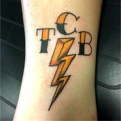 a close up of a person's foot with a lightning bolt tattoo on it