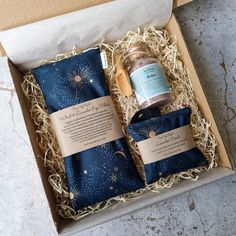 the box contains two items that are wrapped in blue and gold paper with stars on them