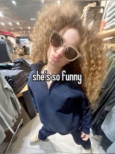 a woman with long curly hair wearing sunglasses