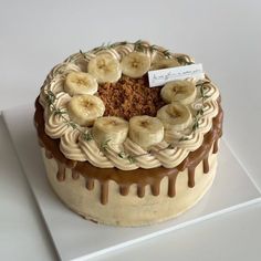 there is a cake with bananas and cinnamon on the top, topped with icing