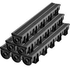 a set of four black plastic drainage grates