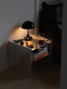 a table with some books and a lamp on it