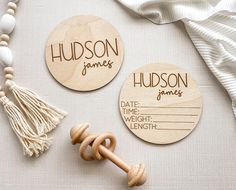 two personalized wooden tags with tassels on them