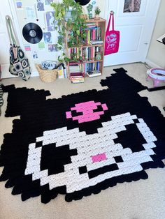 a rug made to look like a cat with pink and white eyes on it's face