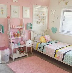 a bedroom with pink walls and lots of toys on the floor, including a bed