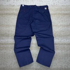 "Vintage Carhartt Khakis Pants Navy Blue Baggy Fit Fire Resistant White Logo Flat Front 90s Skate / Streetwear Condition: 9/10 Men's Size:  Waist: 42\" Length (inseam): 34\" Leg Opening: 9\" Thigh Opening: 15\" Front Rise: 14\"" Vintage Blue Baggy Bottoms, Blue Pants With Belt Loops For Streetwear, Blue Relaxed Fit Work Pants With Pockets, Vintage Blue Pants With Relaxed Fit, Vintage Blue Bottoms With Side Pockets, Blue Cotton Work Pants With Pockets, Vintage Blue Pants With Pockets, Navy Cotton Work Pants With Pockets, Vintage Blue Bottoms With Pockets