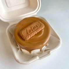 an ice cream sandwich with peanut butter on top in a foam container that is open