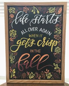 a chalkboard sign that says life starts all over again when it gets crisp in the fall