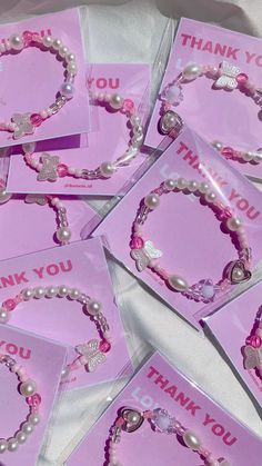 pink thank you cards with pearls and hearts on them are arranged in a pile together