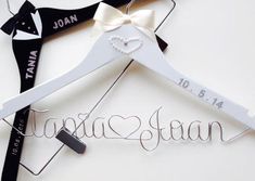 a wedding dress hanger with a bow and name on it