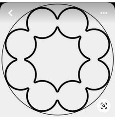 a circular design in black and white, with the center surrounded by four smaller circles