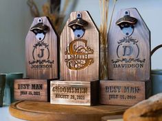 three wooden bottle openers with the names of different wineries on them, sitting on a table