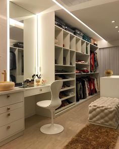 a dressing room with white furniture and lots of closet space