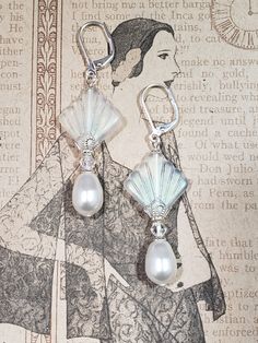 I created these 1920s inspired earrings with my favorite jewelry components - Czech glass beads, Swarovski crystals, and Swarovski pearls. This is a classic Art Deco design; perfect for a 1920s style wedding or party. The Czech beads are shaped like fans; one of the most popular design motifs during the Roaring Twenties. Elegant Swarovski crystals and pearls complete the design. One side of the clear matte Czech beads has an Aurora Borealis coating which gives a subtle shimmer of blue. These ear Vintage Sterling Silver Chandelier Earrings For Wedding, Nickel Free Czech Glass Wedding Jewelry, Elegant Czech Glass Jewelry With Matching Earrings, Vintage Nickel-free Clip-on Earrings For Wedding, Nickel Free Vintage Clip-on Earrings For Wedding, Nickel-free Czech Glass Earrings For Wedding, Nickel-free Czech Glass Wedding Earrings, Vintage Czech Glass Matching Earrings, Elegant Party Jewelry In Czech Glass