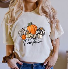 Comfort Colors® Pumpkin Season t-shirt, Gift For Halloween, Halloween Shirt, Cute fall T-shirt, Spooky Season, Halloween Pumpkin Shirt A Comfort Colors shirt is a type of casual t-shirt that is known for its softness, relaxed fit, and muted color palette. Typically made from 100% cotton, these shirts have a vintage feel and are often favored for their comfortable, worn-in look. This classic unisex jersey short sleeve and long sleeve tees fits like a well-loved favorite. Soft cotton and quality print make users fall in love with it over and over again. These t-shirts have-ribbed knit collars to bolster shaping. The shoulders have taping for better fit over time. Dual side seams hold the garment's shape for longer.  *6.1 oz./yd² (US), 10 oz/L yd (CA), 100% ring spun cotton, 30 singles *Garme Orange Crew Neck T-shirt For Fall, Orange Graphic Print T-shirt For Fall, Spooky Orange T-shirt For Fall, Orange Letter Print T-shirt For Fall, Orange T-shirt With Letter Print For Fall, Spooky Short Sleeve T-shirt For Fall, Orange Screen Print T-shirt For Fall, Fall Crew Neck Tops With Custom Print, Orange Graphic Tee For Fall