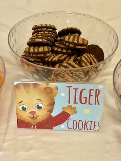 a bowl filled with cookies next to a sign that says tiger cookies on the side