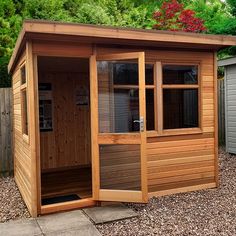 a small wooden shed sitting in the middle of a yard