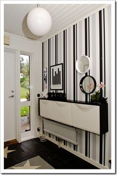 a room with black and white stripes on the wall