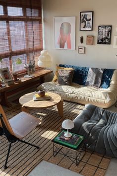 a living room filled with furniture and pictures on the wall