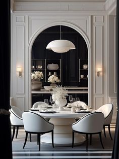 an elegant dining room with black and white decor