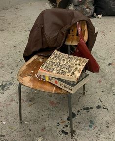 a pile of books sitting on top of a wooden chair