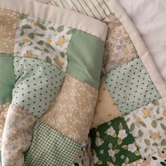 a close up of a patchwork quilt on a bed