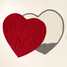 two heart shaped rugs sitting next to each other on top of a white table