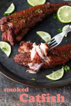 there is a fork in some meat on a plate with lemons and parsley