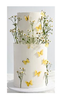 a white cake with yellow flowers and butterflies on it