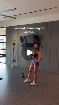 a woman is standing in front of a wall with an ad on it that says, instead of running for cardio