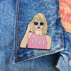 Celebrate Taylor's pop album (that she now owns!) wherever you go with this Enamel Pin! Approximately 1.5" x 1.3".Soft Enamel with a deluxe locking pin back.Enamel pins are collectible, fun, quirky & retro.High Quality and great packaging to give as a gift.Black metal with enamel paint.Great for hats, bags and jackets.The pins are attached to a backing piece and sleeved in a plastic bag for safe shipping.Outlined in gold metal and comes with a deluxe locking pin back. Pop Albums, Taylor Swift 1989, Soft Enamel, Enamel Paint, Pin Backs, Enamel Pin, Paper Gifts, Plastic Bag, Black Metal