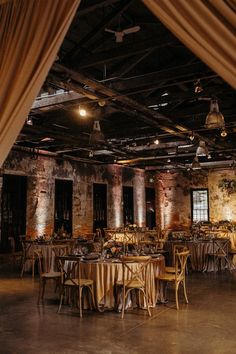 an empty room with tables and chairs set up for a formal function in the middle of it