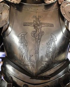 a metal armor with a cross on it