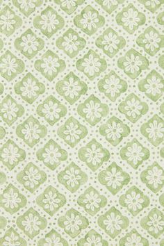 a green and white wallpaper pattern with small flowers on the bottom half of it