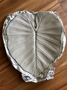 a heart shaped cake sitting on top of a wooden table