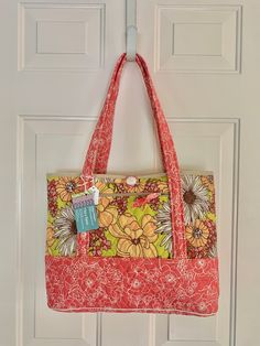 "Quilted tote bag is perfect for everyday! Pretty salmon pink/ivory floral print and yellow, ivory, salmon pink flowers on a lt green background. Outer zip pocket fits cellphone and 3 interior slip pockets for other small items. Loop and button closure. Quilted straps are comfy on your shoulder.   Dimensions: 18\"L x 12\"H x 4\"W 11\" strap drop" Burgundy Purse, Place Mats Quilted, Quilted Tote Bags, Quilted Totes, Everyday Tote, Salmon Pink, Mini Crossbody Bag, Mini Crossbody, Tote Bag Pattern