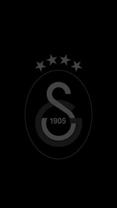 the black and white logo with five stars on it's left side, in front of a dark background