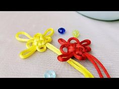 two different colored bows and beads on a table