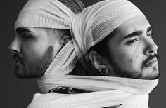 two men with head coverings on their heads and one wearing a scarf around his neck