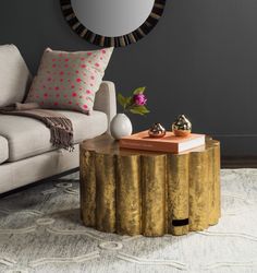 a living room with a couch, coffee table and mirror on the wall above it