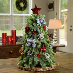 a decorated christmas tree on a wooden table