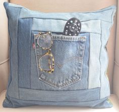 a denim pillow with a pair of glasses in the pocket