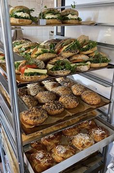 an assortment of sandwiches and pastries in a display case